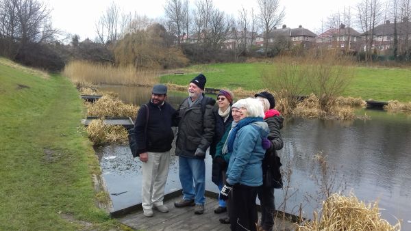 Walkers beside Eastbank Road pond